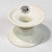 A ceramic 'Harris Stand' by G Rushbrooke Smithfield Ltd, on a circular base with white glaze,