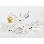 A selection of Swarovski glass figures, including frogs, hedgehog and a butterfly