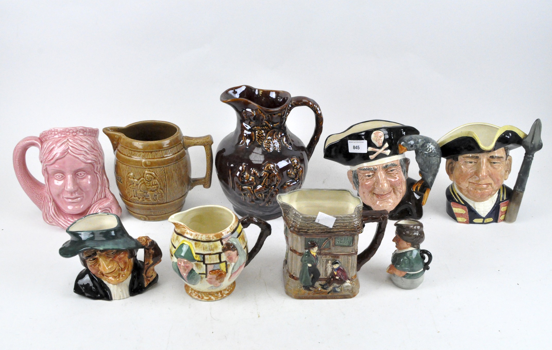 A group of nine jugs including four Royal Doulton examples titled Oliver Twist, Long John Silver,