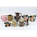 A group of nine jugs including four Royal Doulton examples titled Oliver Twist, Long John Silver,