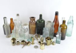 A collection of vintage glass bottles together with stoneware storage jars and more