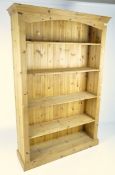 A contemporary pine bookshelf, formed of five tiers,