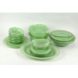 A retro Pyrex green dinner service, including dinner plates, serving dishes,
