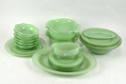 A retro Pyrex green dinner service, including dinner plates, serving dishes,