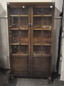 An antique mahogany display cabinet, the front with two glazed doors, opening to reveal six shelves,