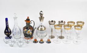 A collection of glasses and decanters for alcoholic drinks,