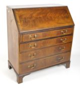 An early 20th century mahogany bureau, the drop front opening to reveal fitted interior,