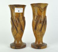 A pair of Pitcairn Island wooden vases, both carved as hands holding a fluted glass, height 20.