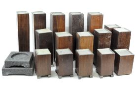 A group of square block wood candle holders of various sizes, some on metal cube feet,