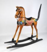 A 20th century child's rocking horse, painted in orange with a black mane and tail,