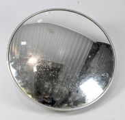 A contemporary convex mirror, of circular form,