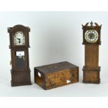 Two miniature wooden models of clocks and a hinged wooden box,