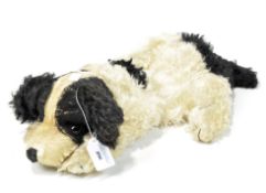 A Merrythought pyjama case, modelled as a dog lying on its front with amber and black glass eyes,