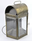 An antique brass lamp modified into an electric light, the domed structure with pierced decoration,