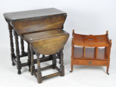 A stained oak gateleg table, of oval form with turned supports, drop leaf table and newspaper rack