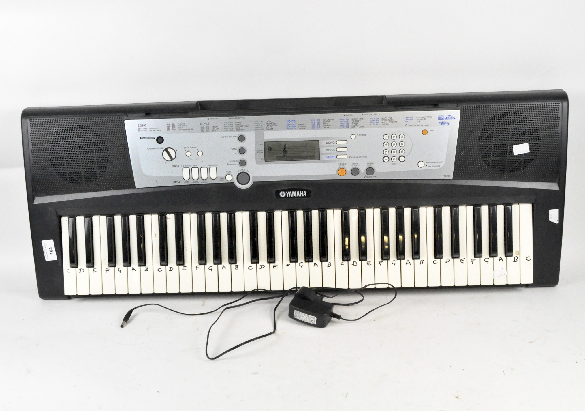 A Yamaha electric keyboard and assorted music,