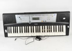 A Yamaha electric keyboard and assorted music,