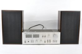 A pair of speakers and a technics stereo integrated amplifier, model SU-72,