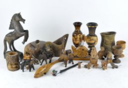 A collection of wooden carvings including various animals such as donkeys, camel, a horse, and more,