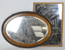 Two wood framed mirrors, the first an early 20th century oval example, the second rectangular