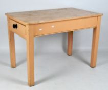 A small painted kitchen table, peach in colour, with single drawer to one end,