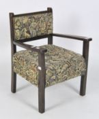 A vintage child's arm chair with traditional floral upholstery, raised on squared supports,