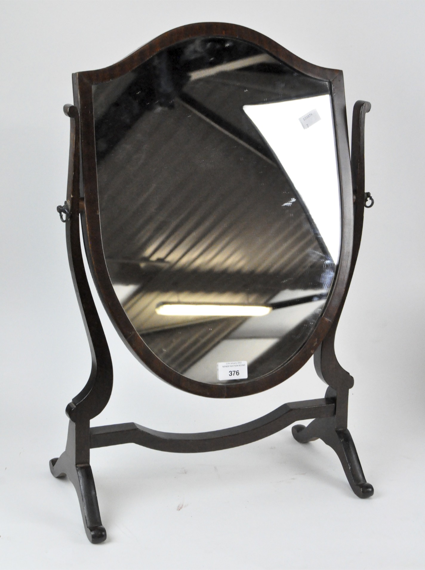 An early 20th century toilet mirror, in a mahogany frame with curved supports,