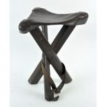 A WWI military folding stool, formed of three folding legs, with leather top,