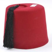A mid century G A Dunn & Co ltd red felt 'Fez' hat, British manufacture,