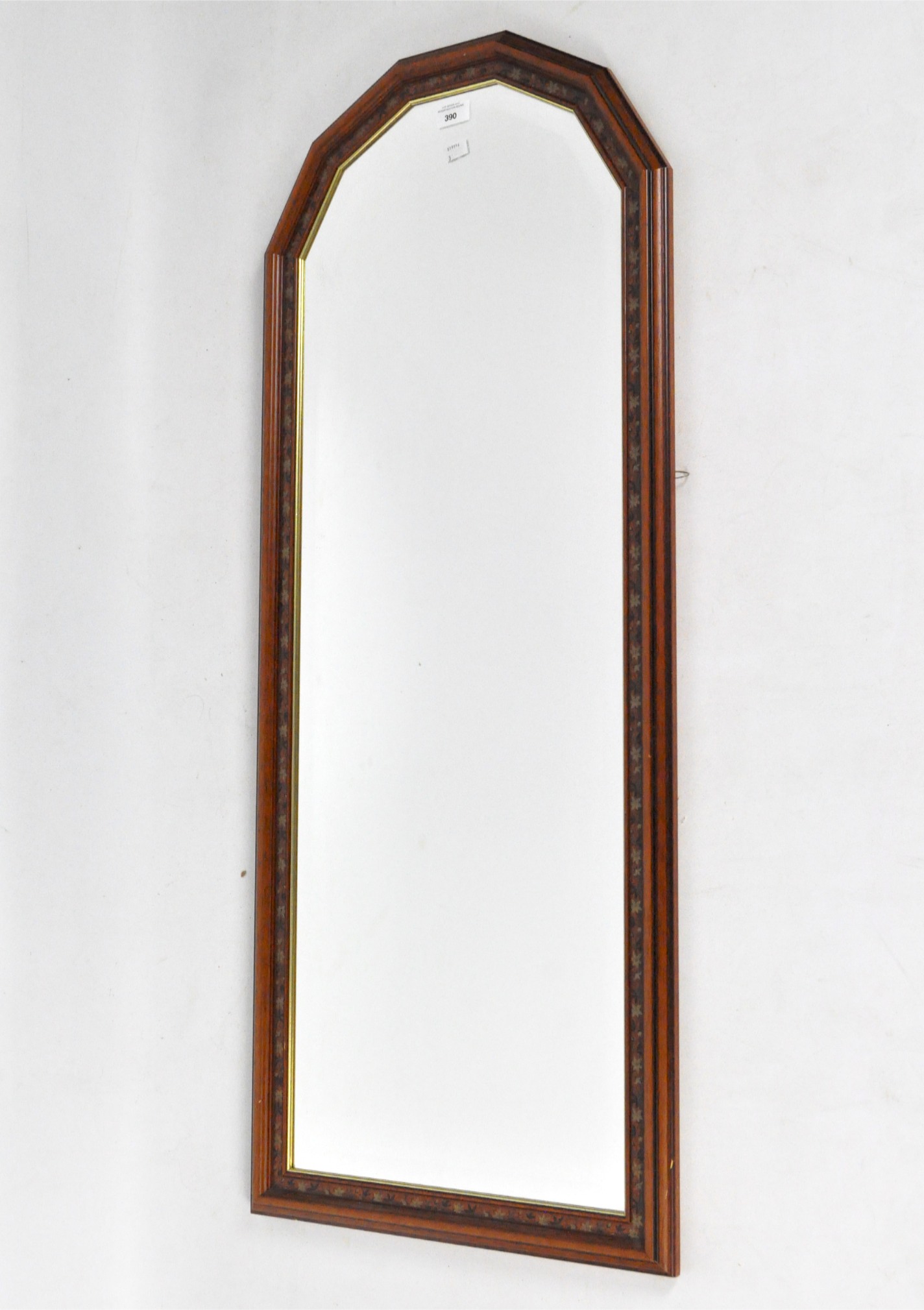 A Victorian bevelled edge wall mirror, the mahogany frame decorated with flowers and foliage,