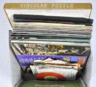 A collection of vinyl records, mostly country and pop music,