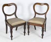 Two Victorian balloon back chairs on turned front supports with pale green textured upholstery,
