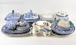 A large selection of blue and white ceramics, including multiple pieces in the 'Willow' pattern,