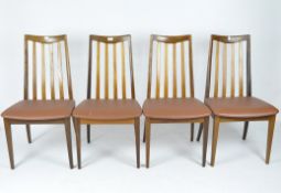 A set of four vintage chairs, with curved wooden frames and tapered legs,