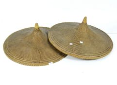 Two oriental conical labourer straw hats,