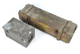 A wooden ammunitions box and a metal trunk,