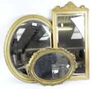 Three giltwood mirrors, including a reeded rectangular example and two circular mirrors