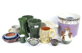 A collection of 20th century pottery, including a puzzle jug, Torquay pottery bowl and salt shaker,