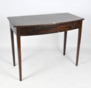 A 20th century mahogany veneered hall table with a curved front, one drawer underneath,