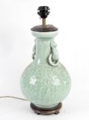 A Chinese celadon glazed baluster vase adapted as a lamp, with beast and ring handles,