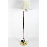 A contemporary floor lamp, the gilt metal structure supported on a circular base,