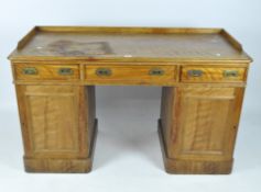 A 20th century wooden desk, the solid top with curved edges and three drawers beneath,