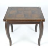 A contemporary mahogany table, the folding top supported by four curved legs,
