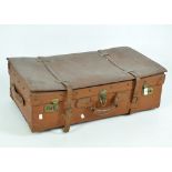 A vintage brown leather suitcase, with a carry handle to the top and brass locks and clasps,