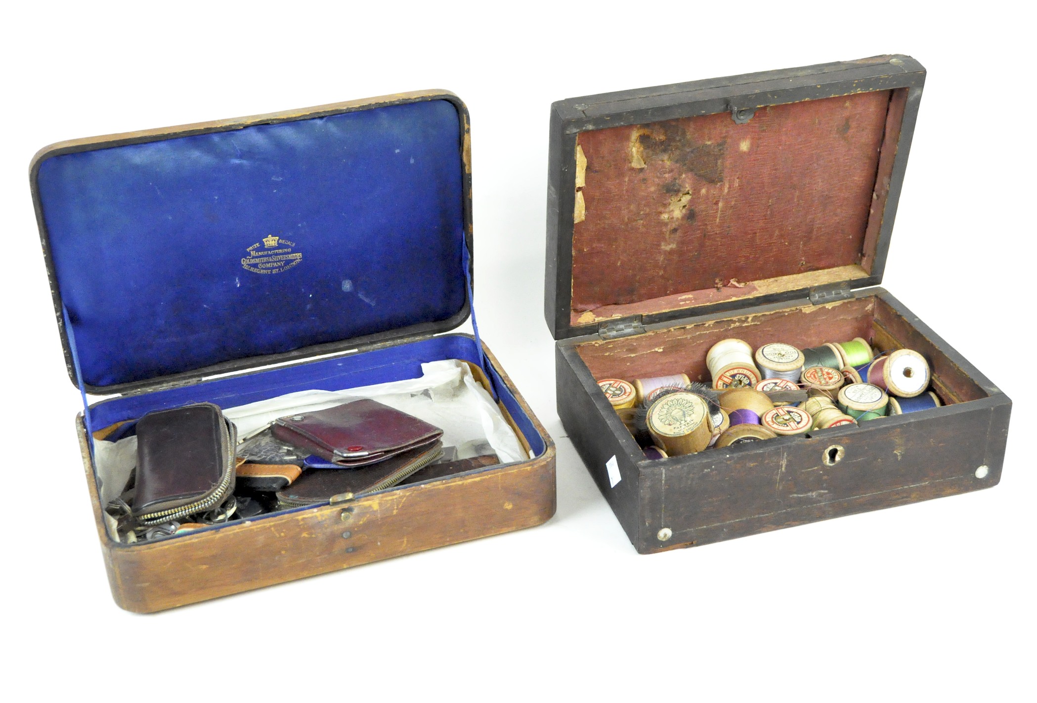 Two wooden storage boxes containing a selection of items, including cotton reels,
