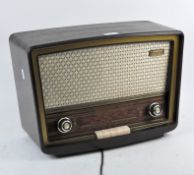 A vintage Stella radio, within a tapered bakelite frame,