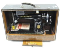 A late 19th century Singer sewing machine, with manual wind and black and gilt decoration,