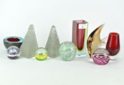 A collection of contemporary glass paperweights and two-colour vases,