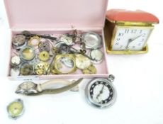 A collection of incomplete watches and components, and a travelling alarm clock,