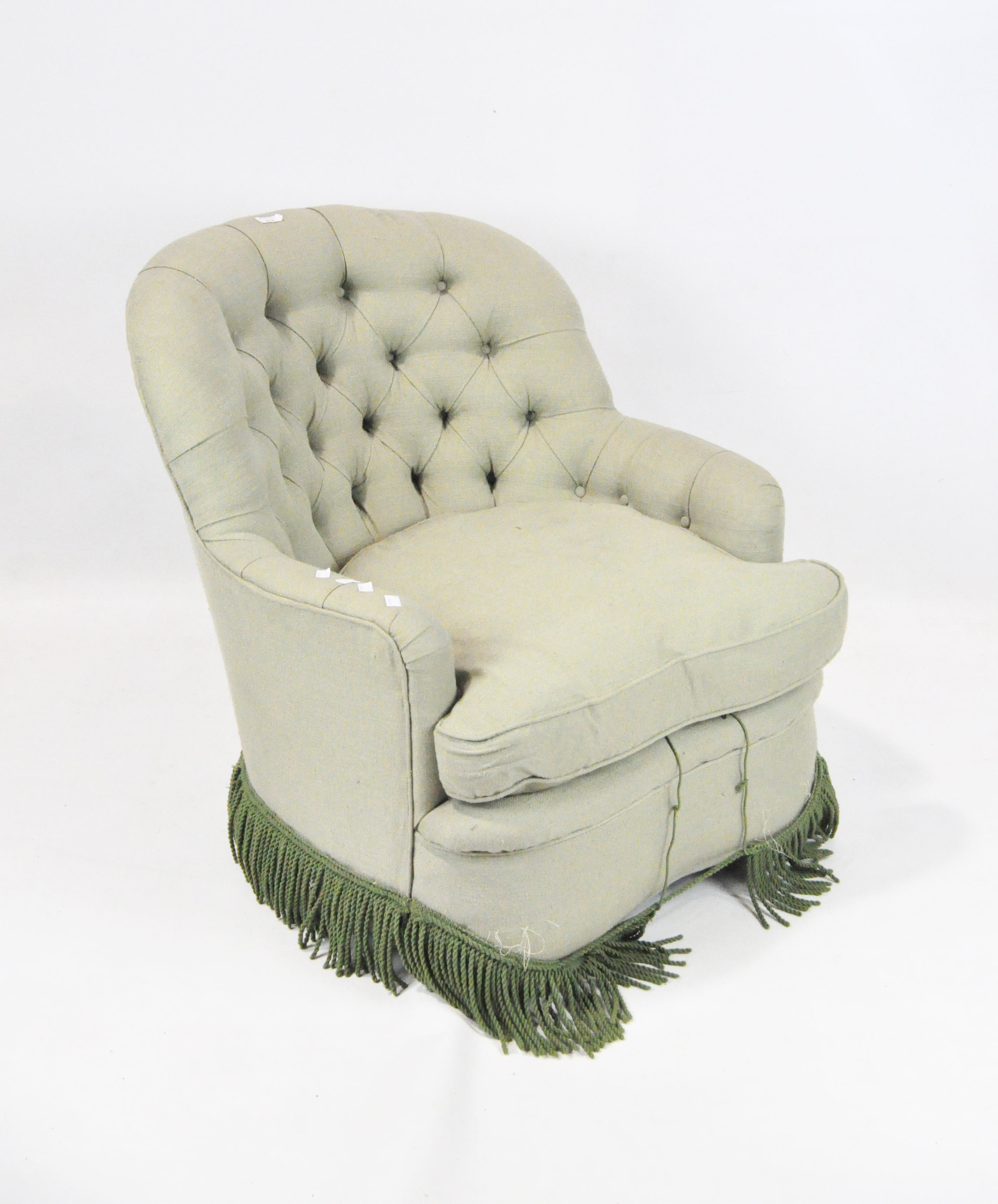 A pale green upholstered button back armchair,